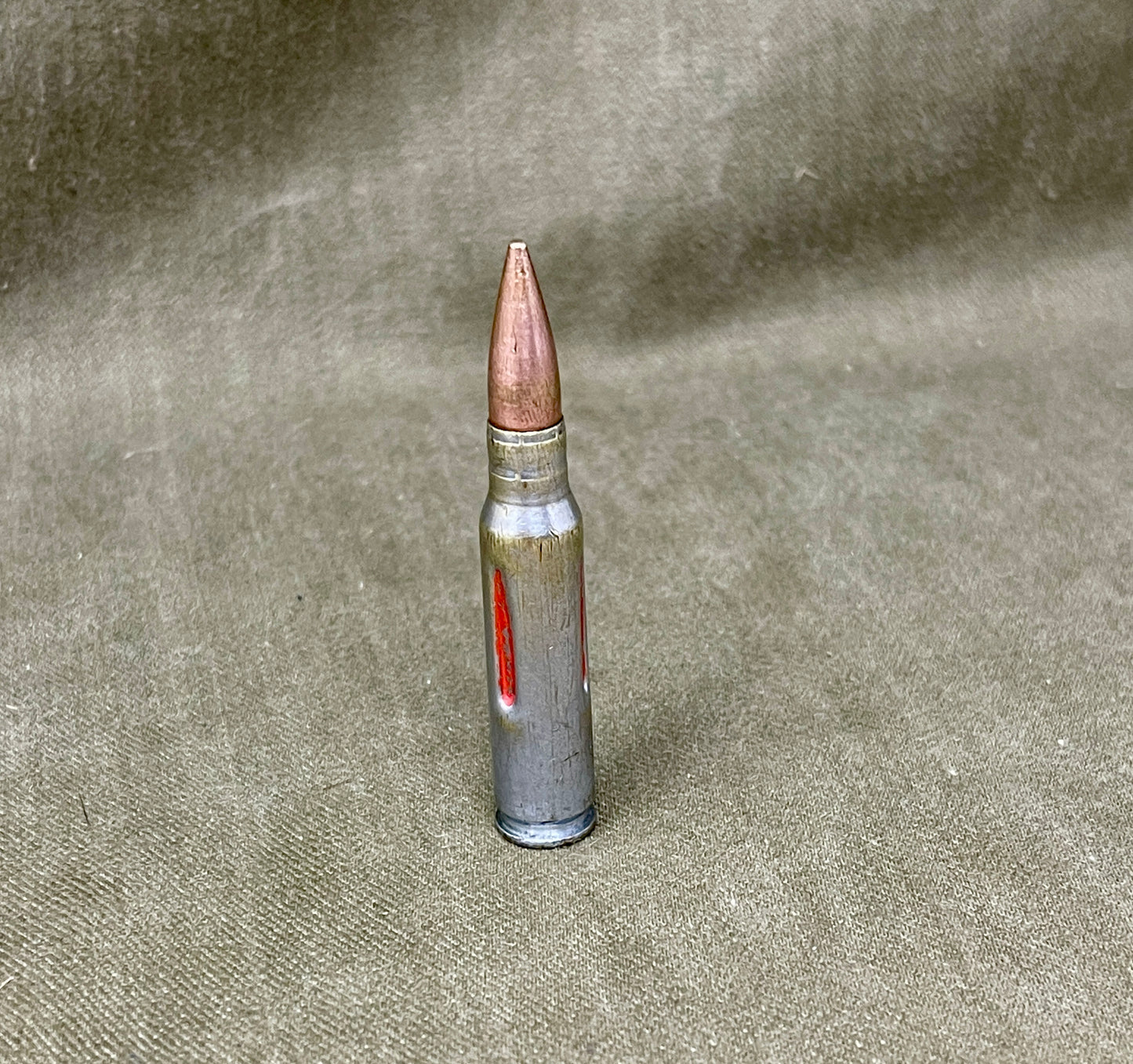 Bullet on a textured beige surface