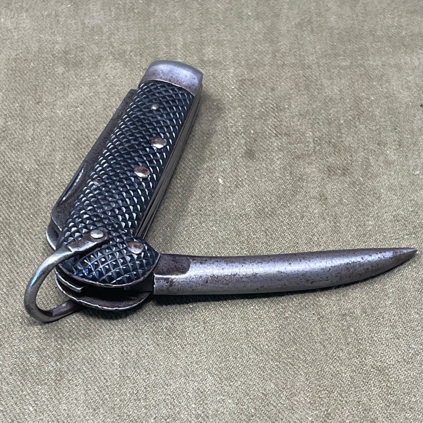 A nice example of a British 1942 Dated Pocket Jack Knife made by Clarke & Son of Sheffield  The blades are in good condition, the chequered Bakelite grip is intact and all the blades lock and close as they should. The steel can opener is in good condition