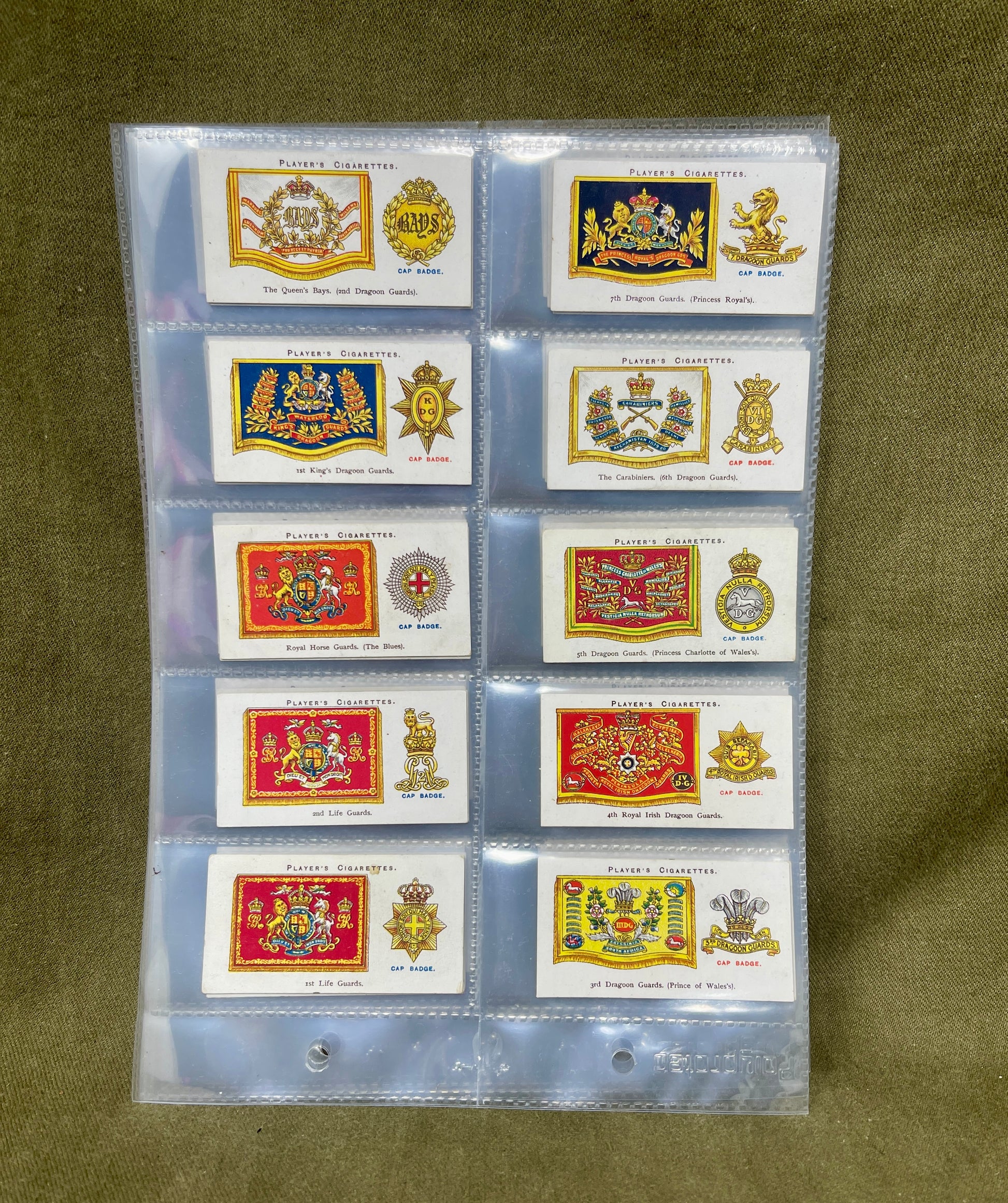 "Discover the John Player & Sons 'Drum Banners and Cap Badges' cigarette cards, featuring stunning illustrations and historical insights into British military insignia. A must-have collectible for military history enthusiasts."