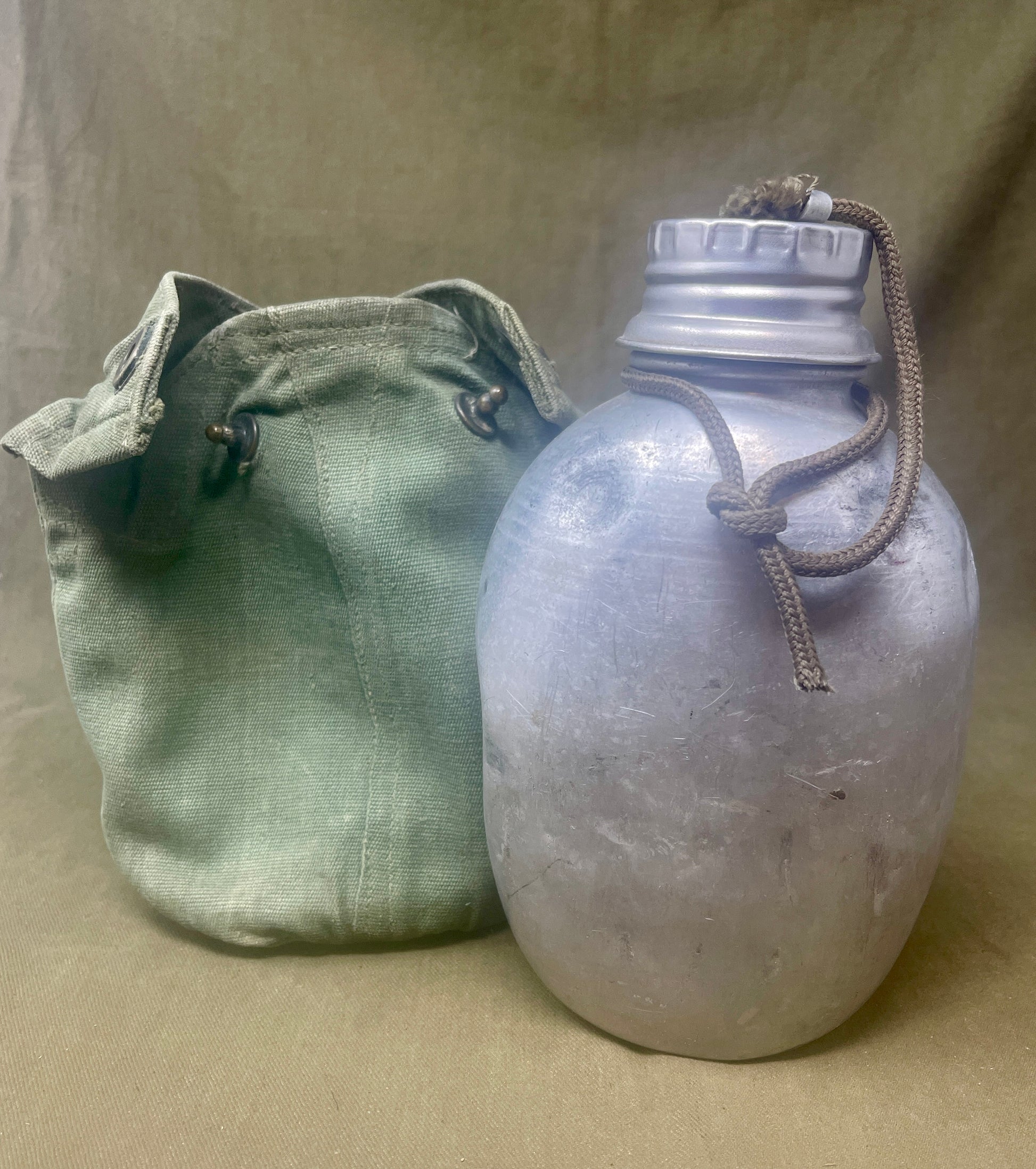 "Discover the British Army 1944 Pattern Water Bottle and Carrier, a durable and functional piece of WWII military equipment. A valuable collectible for enthusiasts of military history."