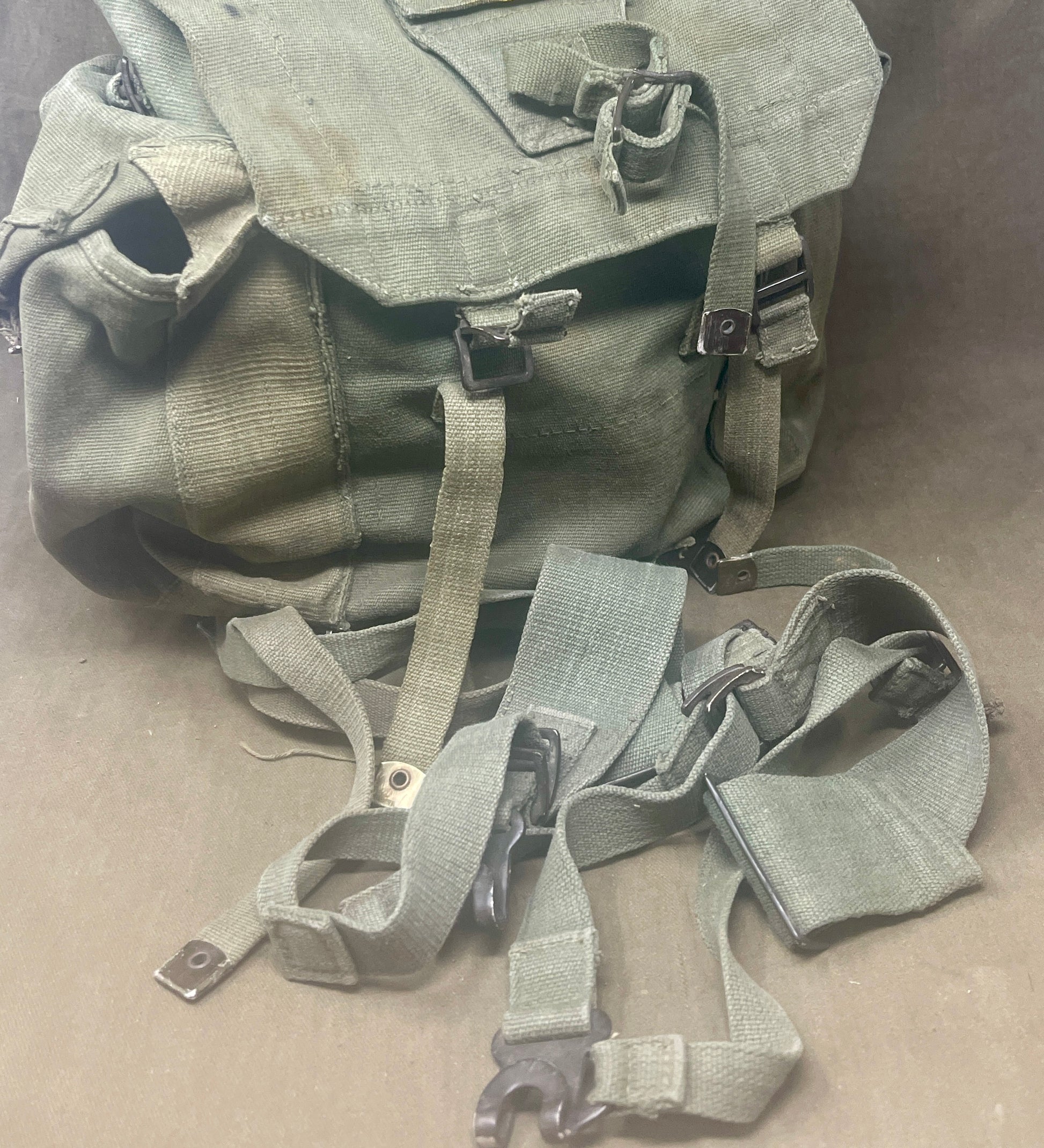 "Explore the 1944 Pattern Small Pack with left and right webbing straps, a durable piece of British military gear from World War II. A must-have collectible for military history enthusiasts."