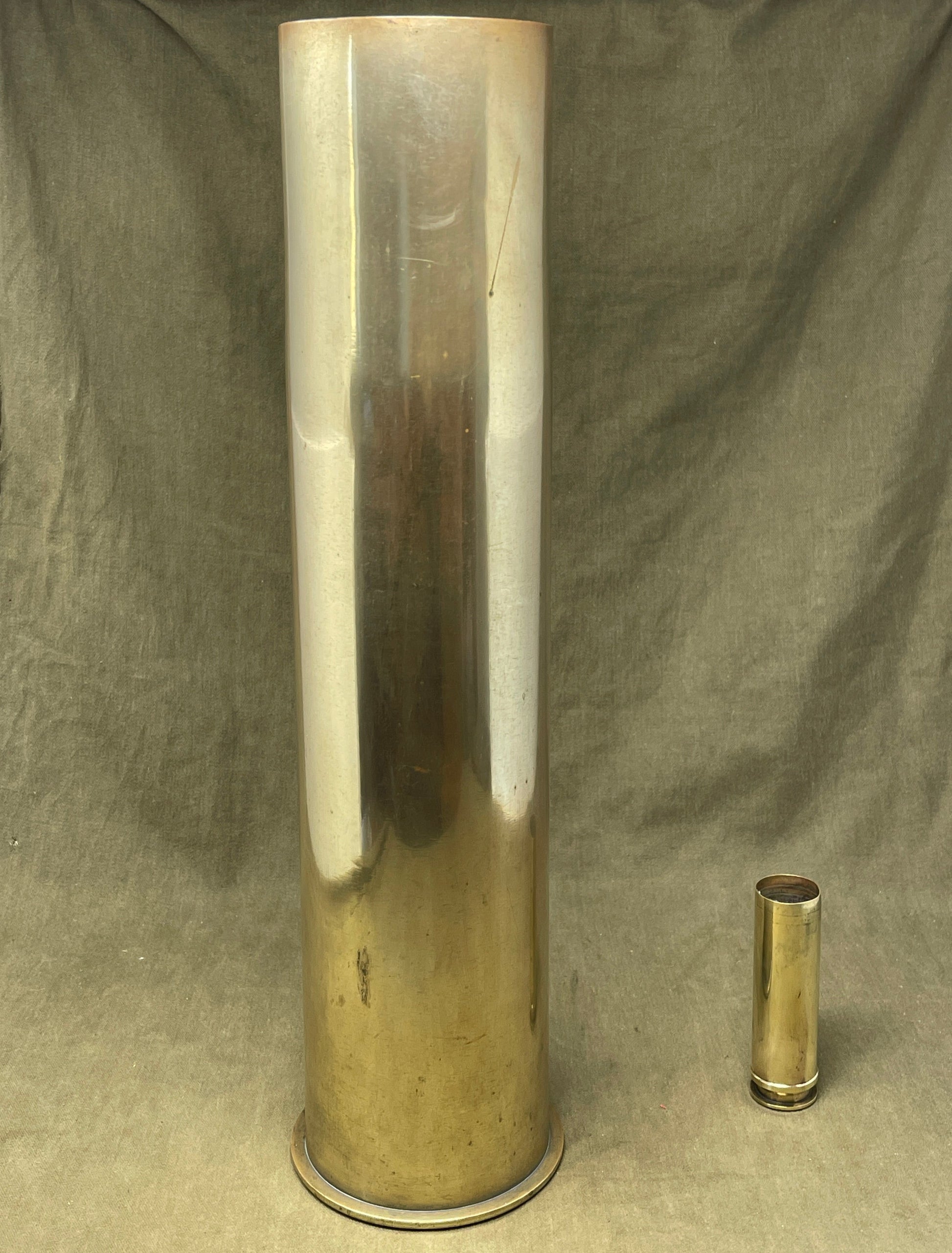German brass 105mm artillery shell case was later used as an umbrella stand. The base is impressed 'Karth. Sp.255 446 MAI 1917 PATRONENFABRIK KARLSRUHE'. The striker is impressed 'FL 14B Sb'.