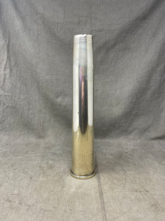 This WWI trench art brass shell case vase is a striking example of craftsmanship born from the battlefields of the First World War. Fashioned from an empty brass shell casing, it showcases the creativity and skill of soldiers or artisans who transformed remnants of war into beautiful, functional works of art. Often adorned with intricate hand-engraved patterns, floral motifs, or military insignia, each piece is unique and tells its own story. Polished to highlight the rich patina of aged brass, this vase is