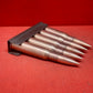 "Discover 5 authentic 7.62x54mm Russian inert cartridges on a classic stripper clip. Perfect for collectors and enthusiasts, these safe, deactivated rounds showcase military history."