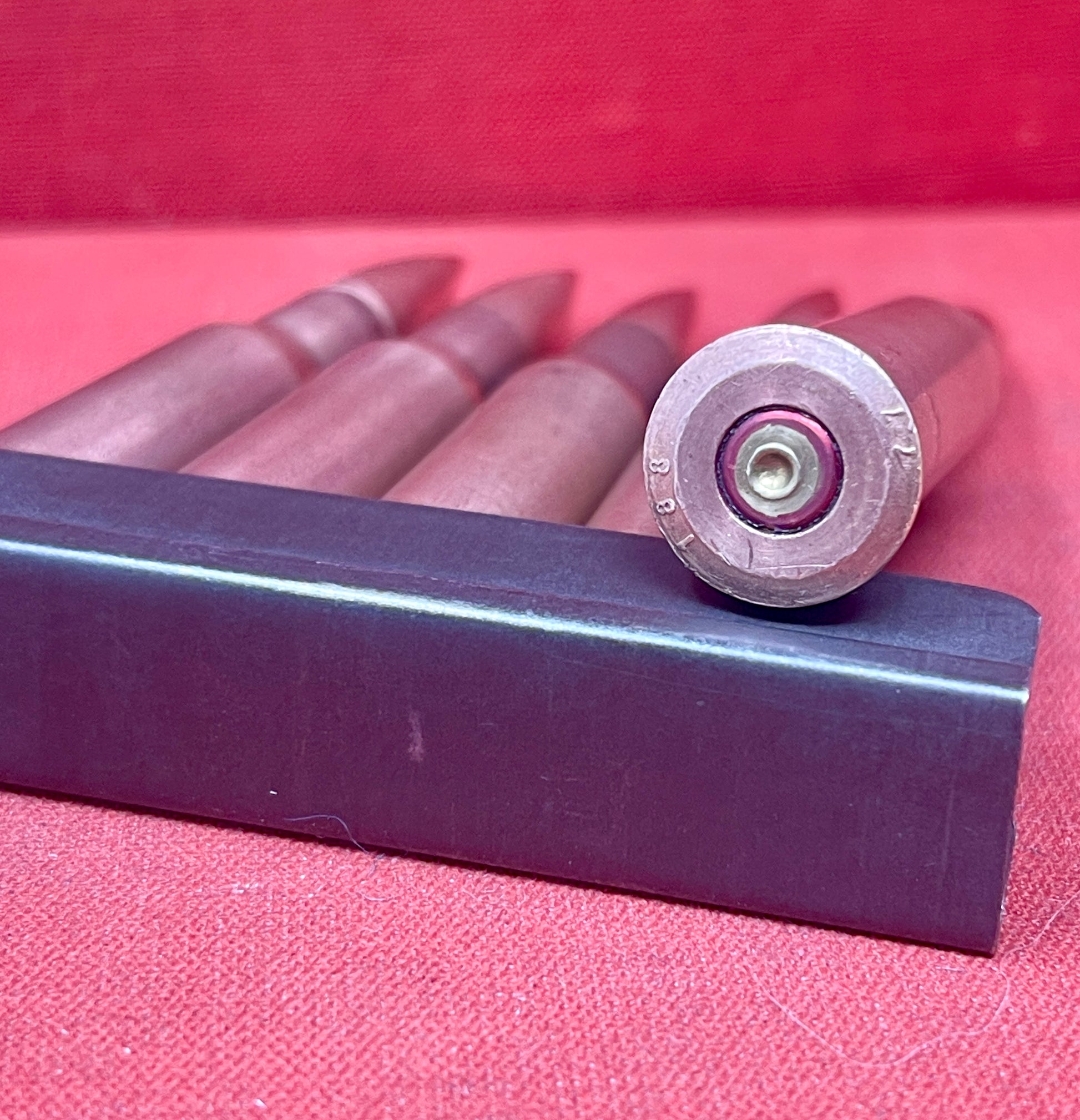 "Discover 5 authentic 7.62x54mm Russian inert cartridges on a classic stripper clip. Perfect for collectors and enthusiasts, these safe, deactivated rounds showcase military history."