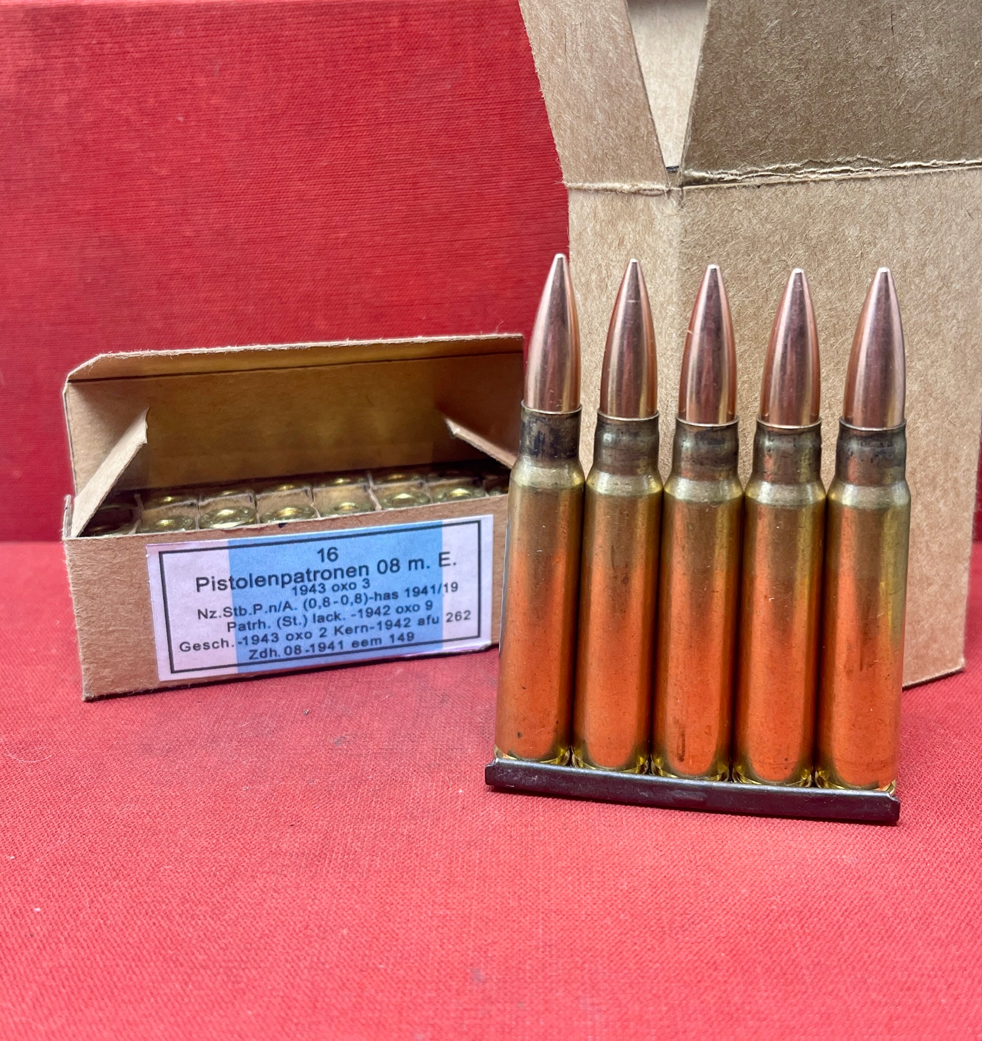 Explore this WWII German Small Arms Ammunition Set, featuring 16 inert 9mm Luger rounds with inert primers and 15 inert 7.92x57mm K98 rounds on three stripper clips. Packaged in handmade replica boxes, this bespoke kit is perfect for collectors and enthusiasts.