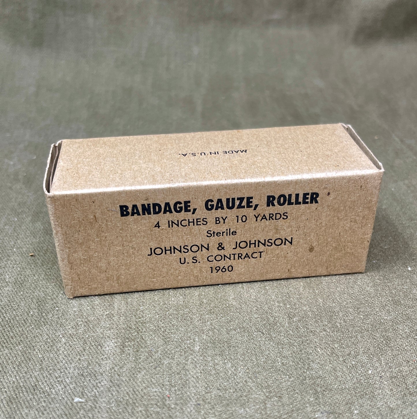 The U.S. Army Bandage, Gauze, Roller, 4 Inch by 10 Yards, Sterile was a military-issue medical supply used for wound dressing and stabilization. Manufactured by Johnson & Johnson under a U.S. government contract in 1960, this sterile gauze bandage was essential for treating injuries in field conditions.

Measuring 4 inches wide and 10 yards long, the bandage was designed for versatility in wound management, allowing medics and soldiers to wrap and secure dressings, control bleeding, and protect wounds from 