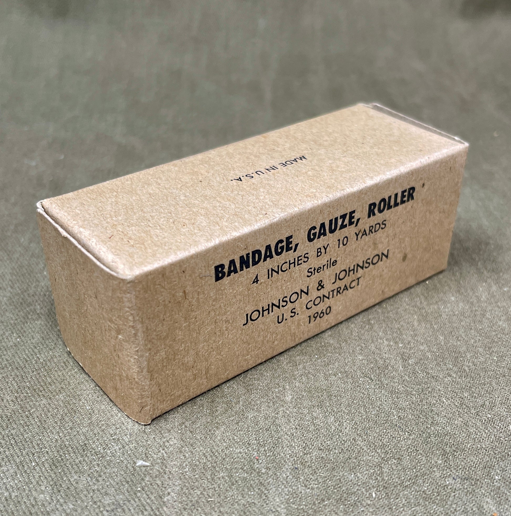 The U.S. Army Bandage, Gauze, Roller, 4 Inch by 10 Yards, Sterile was a military-issue medical supply used for wound dressing and stabilization. Manufactured by Johnson & Johnson under a U.S. government contract in 1960, this sterile gauze bandage was essential for treating injuries in field conditions.

Measuring 4 inches wide and 10 yards long, the bandage was designed for versatility in wound management, allowing medics and soldiers to wrap and secure dressings, control bleeding, and protect wounds from 