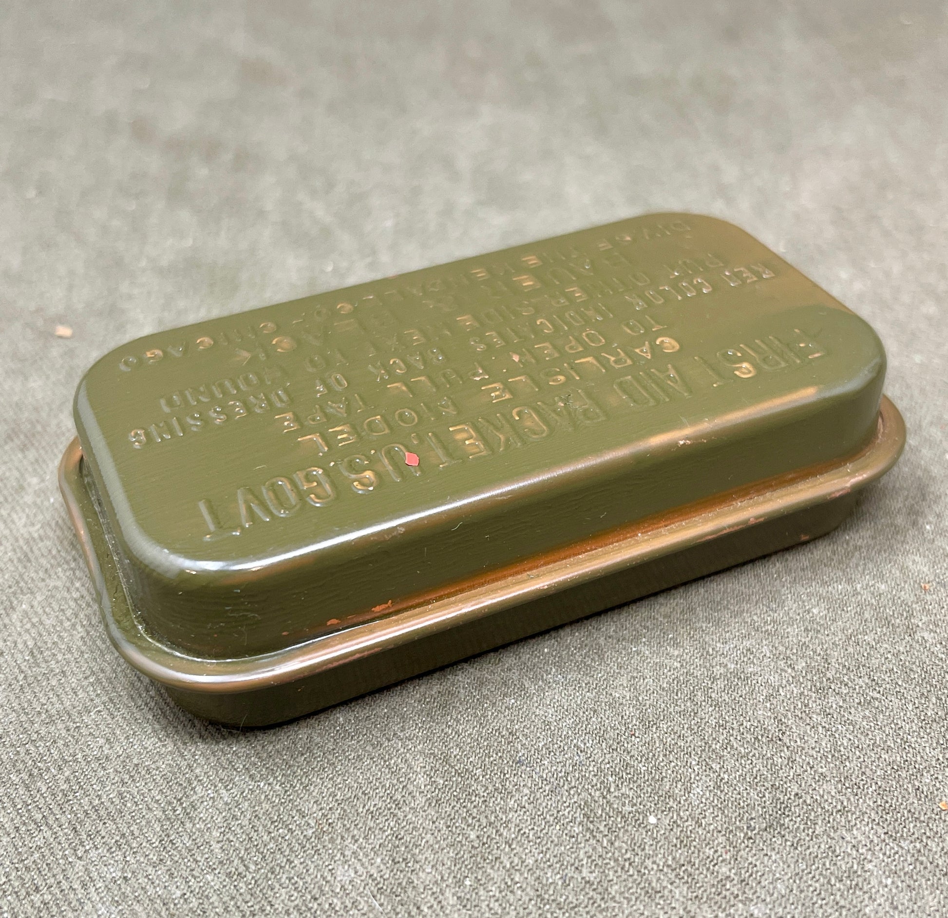 Original WWII U.S. Army First Aid Dressing Packet, Carlisle Model by Bauer & Black, Kendall Co. Sealed olive drab tin in excellent condition. Rare military collectible!