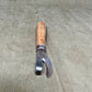 Authentic WWII German Wehrmacht can opener with original wood handle. A rare and practical piece of wartime field equipment for collectors and historians.

