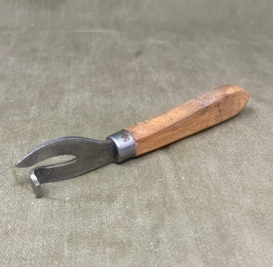 Authentic WWII German Wehrmacht can opener with original wood handle. A rare and practical piece of wartime field equipment for collectors and historians.


