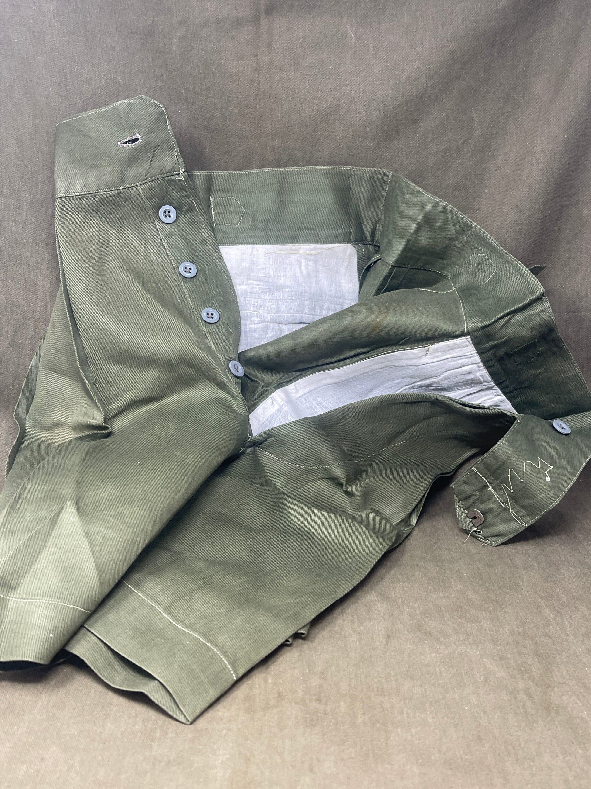 Original 1950s British Army Jungle Green shorts, locally made, Size 3 (30"-31" waist). Excellent condition with classic military design—ideal for collectors or re-enactors.