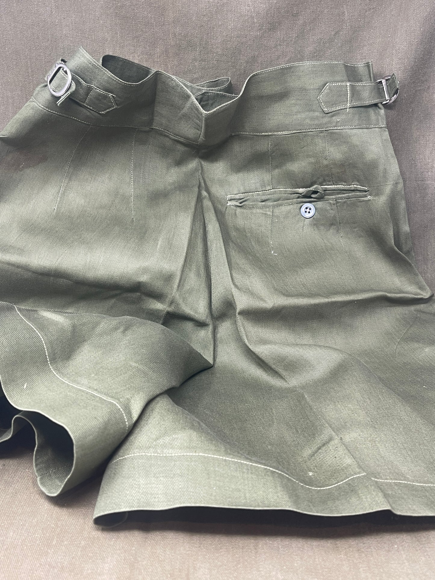 Original 1950s British Army Jungle Green shorts, locally made, Size 3 (30"-31" waist). Excellent condition with classic military design—ideal for collectors or re-enactors.