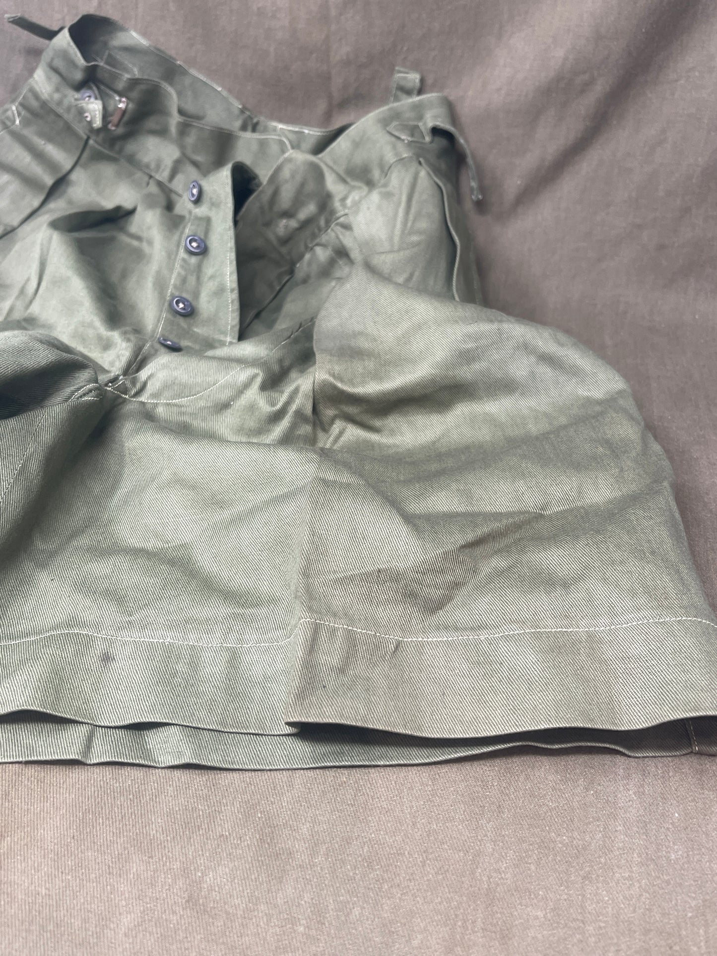 Original 1950s British Army Jungle Green shorts, locally made, Size 3 (30"-31" waist). Excellent condition with classic military design—ideal for collectors or re-enactors.