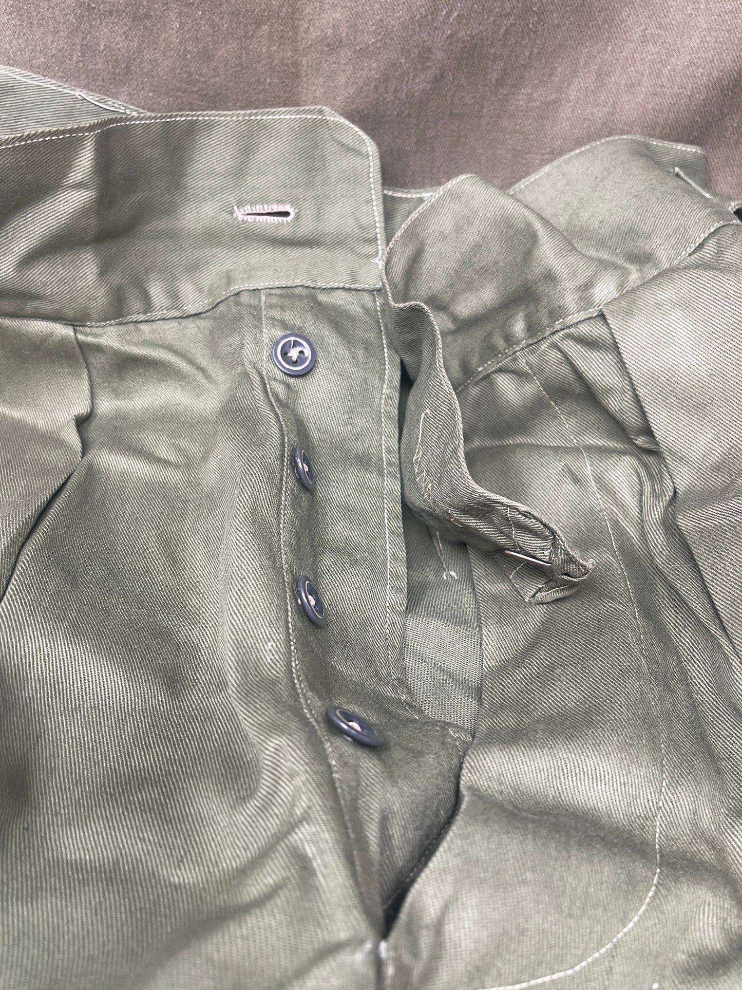 Original 1950s British Army Jungle Green shorts, locally made, Size 3 (30"-31" waist). Excellent condition with classic military design—ideal for collectors or re-enactors.