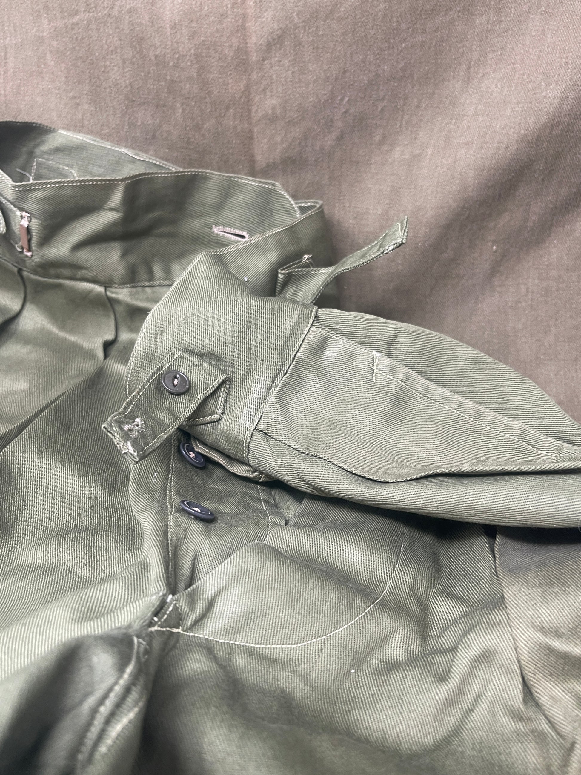 Original 1950s British Army Jungle Green shorts, locally made, Size 3 (30"-31" waist). Excellent condition with classic military design—ideal for collectors or re-enactors.