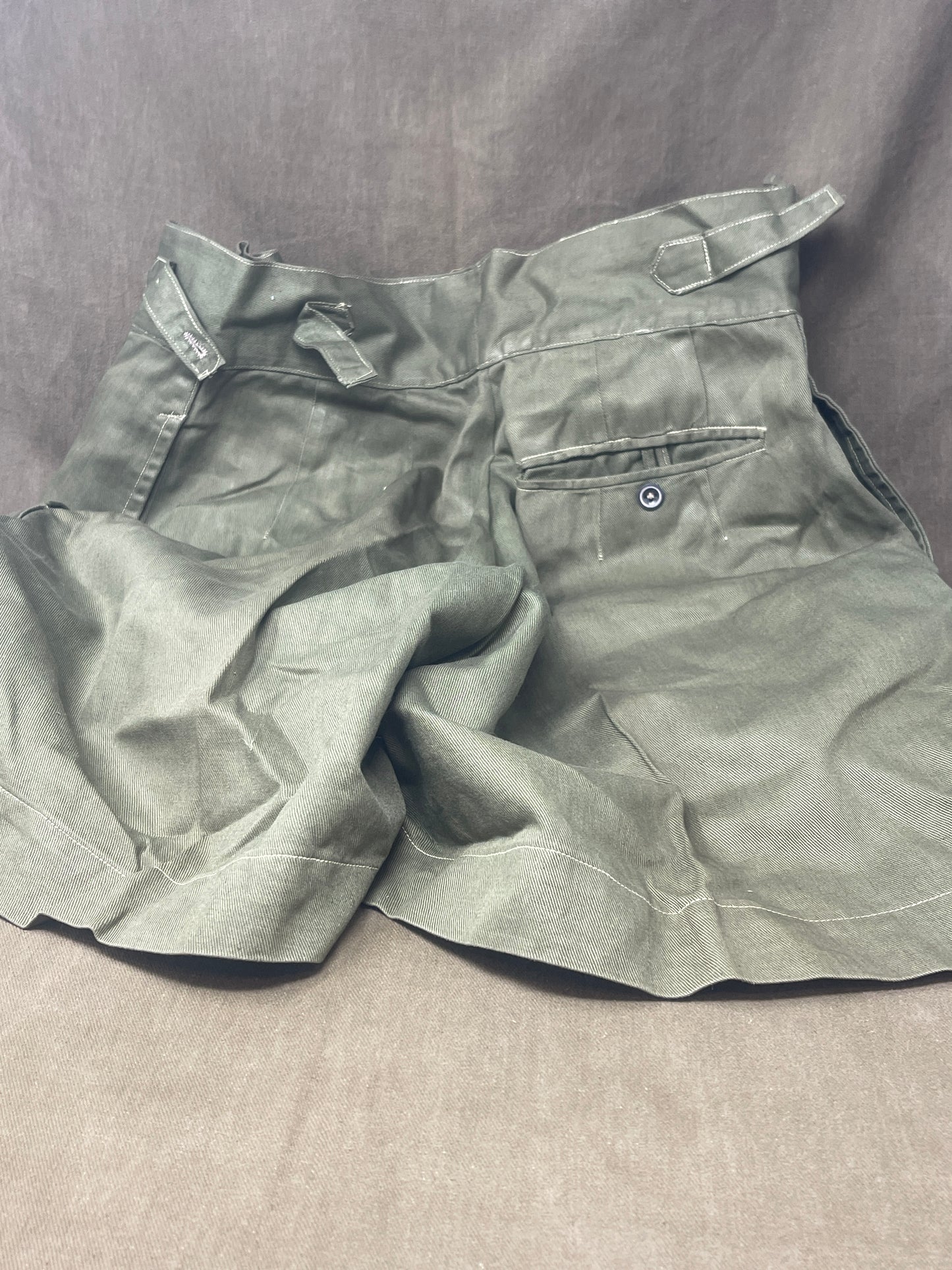 Original 1950s British Army Jungle Green shorts, locally made, Size 3 (30"-31" waist). Excellent condition with classic military design—ideal for collectors or re-enactors.