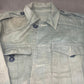 This original 1951-dated British Army Jungle Green Bush Jacket is a superb example of early post-war tropical combat clothing, manufactured by the reputable N. Lotery & Co. Ltd. Made from sturdy, breathable cotton in classic Jungle Green, this jacket was designed for use in humid and challenging environments such as Malaya and other post-war theatres of operation.

The jacket is in excellent condition, showing minimal signs of wear, with its color, stitching, and structural integrity all remarkably well-pre