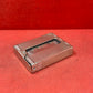 Add a touch of vintage charm to your collection with this original British brass hinged match holder, dating to the 1920s. Crafted from solid brass with a warm aged patina, it features a hinged lid and internal compartment designed to keep matches dry and ready for use. Compact and practical, it would have been a common pocket or travel item in the early 20th century. Ideal for collectors of antique smoking accessories, vintage EDC items, or brassware. A beautiful and functional relic from post-WWI Britain,
