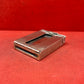 Add a touch of vintage charm to your collection with this original British brass hinged match holder, dating to the 1920s. Crafted from solid brass with a warm aged patina, it features a hinged lid and internal compartment designed to keep matches dry and ready for use. Compact and practical, it would have been a common pocket or travel item in the early 20th century. Ideal for collectors of antique smoking accessories, vintage EDC items, or brassware. A beautiful and functional relic from post-WWI Britain,