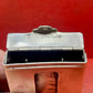 Add a touch of vintage charm to your collection with this original British brass hinged match holder, dating to the 1920s. Crafted from solid brass with a warm aged patina, it features a hinged lid and internal compartment designed to keep matches dry and ready for use. Compact and practical, it would have been a common pocket or travel item in the early 20th century. Ideal for collectors of antique smoking accessories, vintage EDC items, or brassware. A beautiful and functional relic from post-WWI Britain,