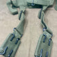 This is an original British Army 1958 Pattern Webbing Yoke, a vital component of the iconic '58 Pattern personal load-carrying system. Issued throughout the Cold War period, this yoke was designed to evenly distribute the weight of webbing pouches and equipment across the shoulders for improved comfort during extended operations.

Constructed from durable olive green webbing, the yoke features adjustable straps, metal fittings, and reinforced stitching for reliable use in the field. It connects securely to 