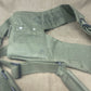 This is an original British Army 1958 Pattern Webbing Yoke, a vital component of the iconic '58 Pattern personal load-carrying system. Issued throughout the Cold War period, this yoke was designed to evenly distribute the weight of webbing pouches and equipment across the shoulders for improved comfort during extended operations.

Constructed from durable olive green webbing, the yoke features adjustable straps, metal fittings, and reinforced stitching for reliable use in the field. It connects securely to 