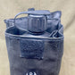 Gray water bottle holder with a water bottle on a beige background