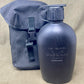 Blue water bottle with carrying strap on a beige background
