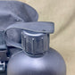 Close-up of a black water bottle cap on a beige background