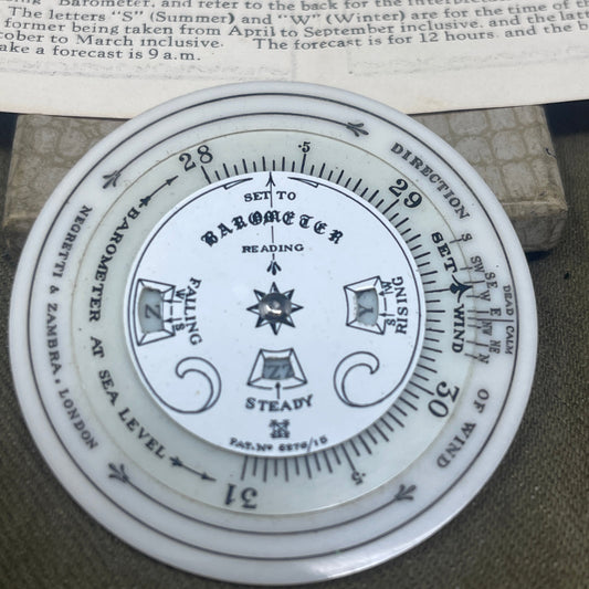 Close-up of a wind gauge with text and symbols on a textured surface