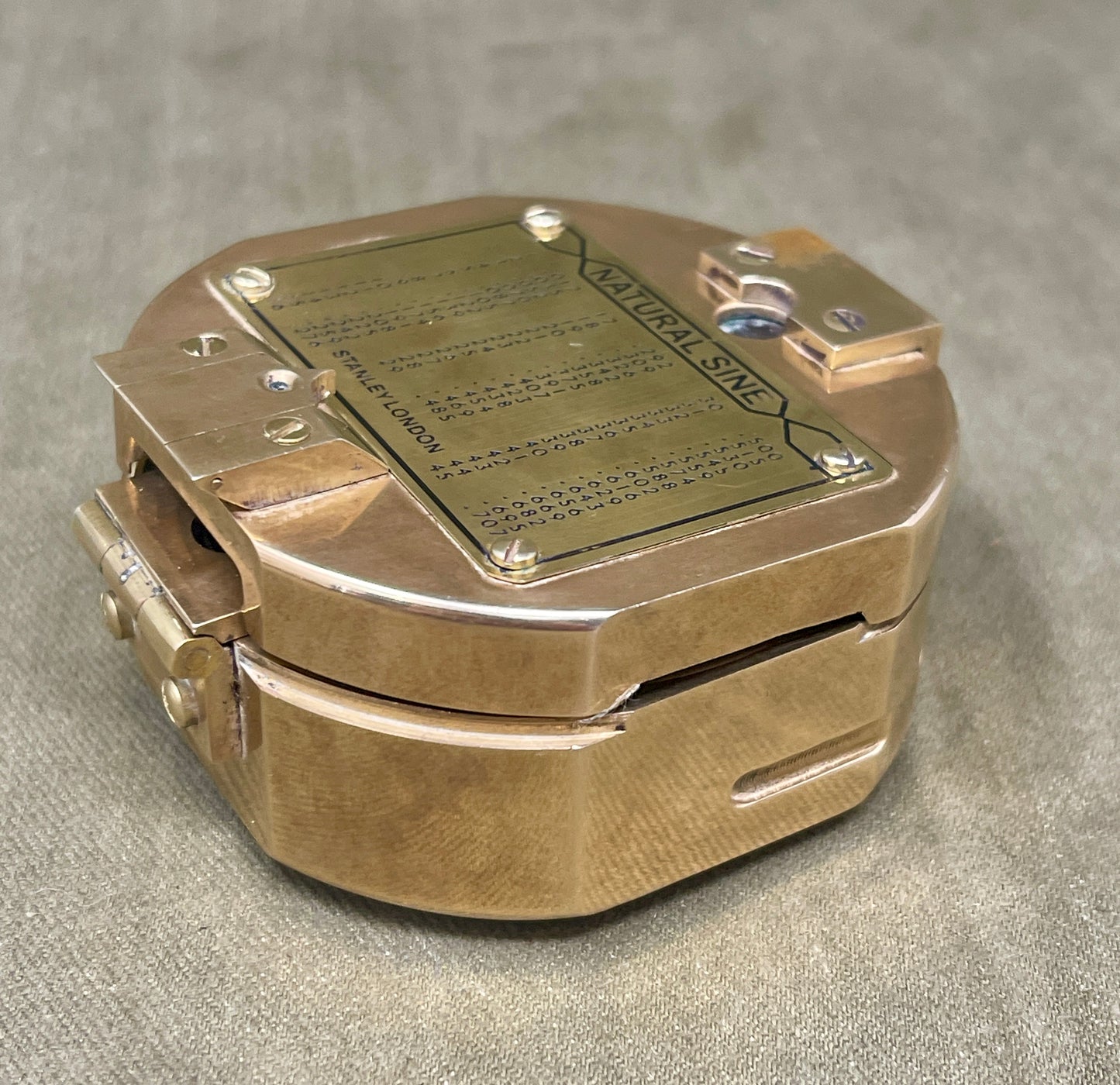 Bronze-colored metal box with a label on a gray background