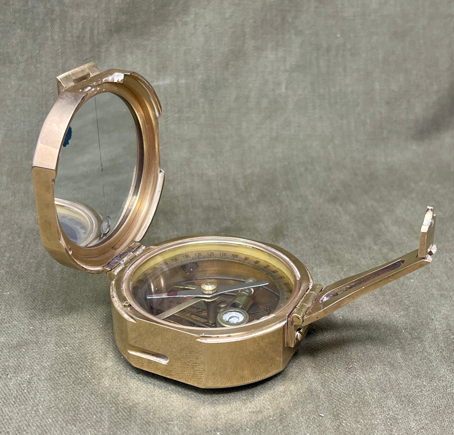 Brass compass on a gray background