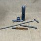 Set of gun cleaning tools on a beige fabric background