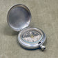 Silver compass on a textured surface