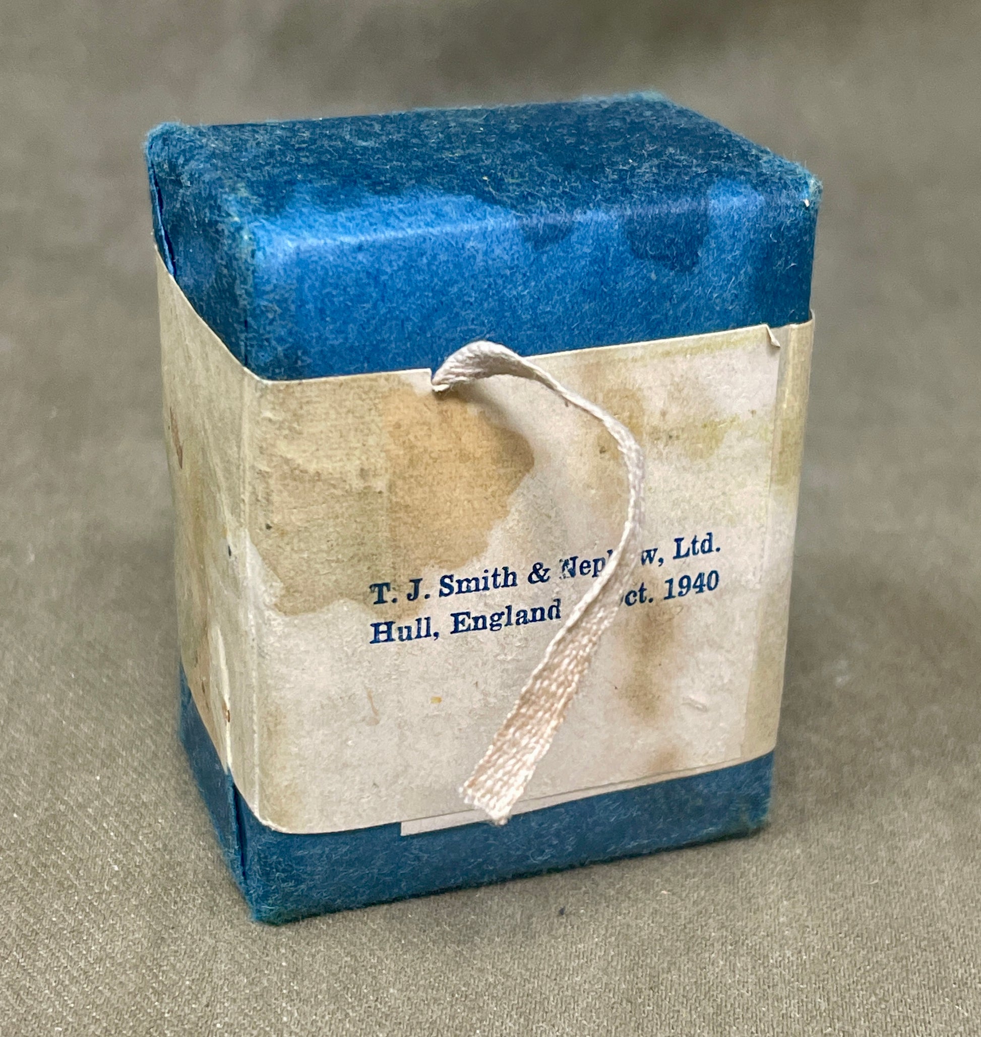 Original 1940 sealed compressed triangular bandage by T. J. Smith & Nephew B.P.C. Wartime medical supply in excellent preserved condition.