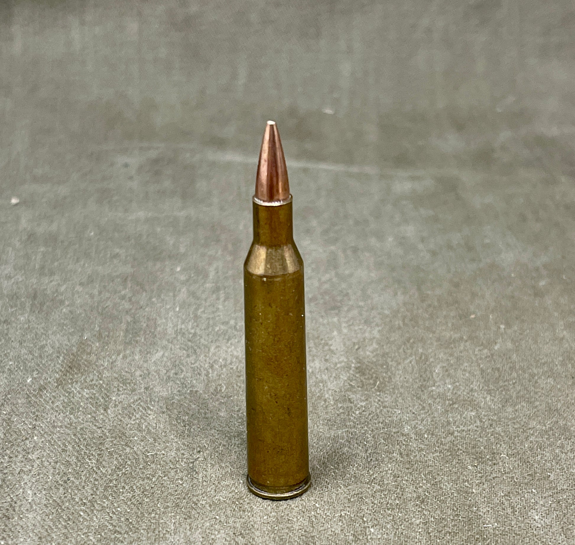This is an original WW2-era Super .220 Swift round, professionally rendered completely inert for safe collecting and display purposes. The cartridge retains its original full metal jacketed projectile and brass casing, featuring the correct wartime Super headstamp. It has been expertly deactivated, with the primer replaced by an inert one and all propellant removed. The .220 Swift was known for its high velocity and flat trajectory, originally developed in the 1930s and occasionally used for experimental or