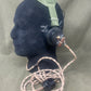 Black airbag with green strap and coiled hose on a gray background