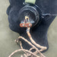 Close-up of a black watch with a brown strap on a dark surface