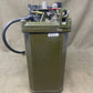 Mechanical device with a rectangular box and cylindrical component on a beige background