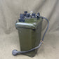 Green electrical box with wiring on a beige background