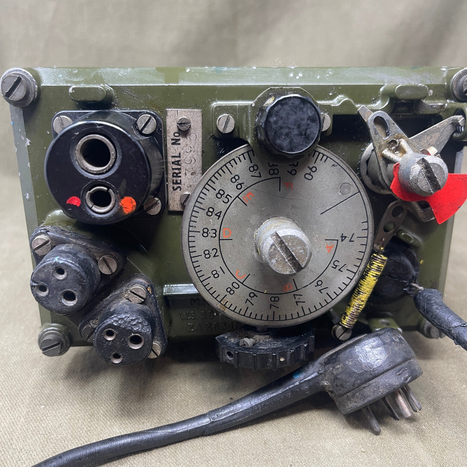 Vintage electronic device with dials and connectors on a beige background