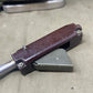 Close-up of a mechanical tool on a textured surface