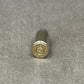 Bullet casing on a gray textured surface