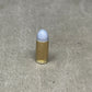 Bullet casing with a white bullet on a gray concrete surface