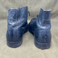 Pair of blue leather boots on a gray background
