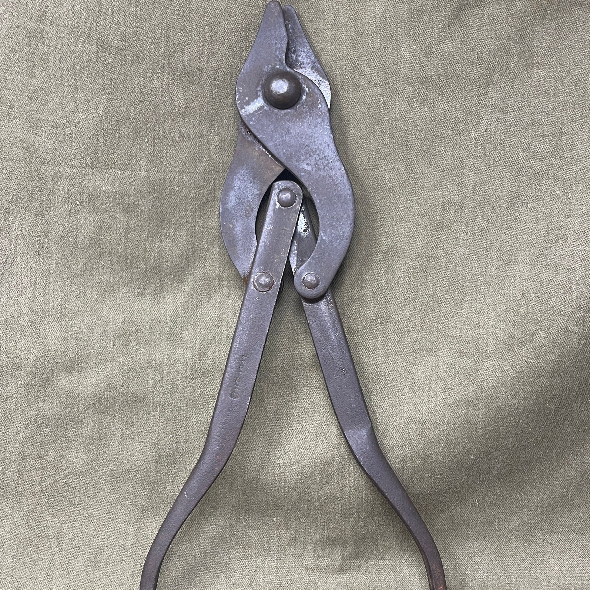 Original WWII British Wire Cutters, dated 1941 and manufactured by C.H.P., are durable steel tools designed for cutting barbed wire and battlefield obstacles. Featuring a spring-loaded mechanism and ergonomic handles, they were essential for British soldiers. Valued by collectors, these cutters represent wartime ingenuity and quality