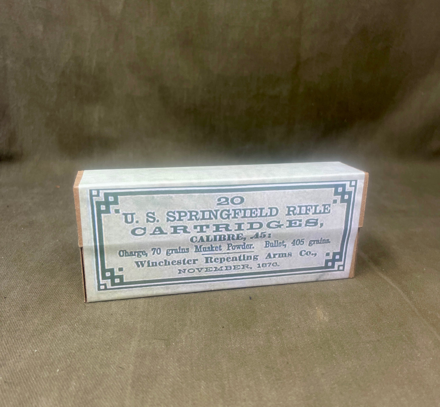 Box of U.S. Springfield rifle cartridges on a brown background