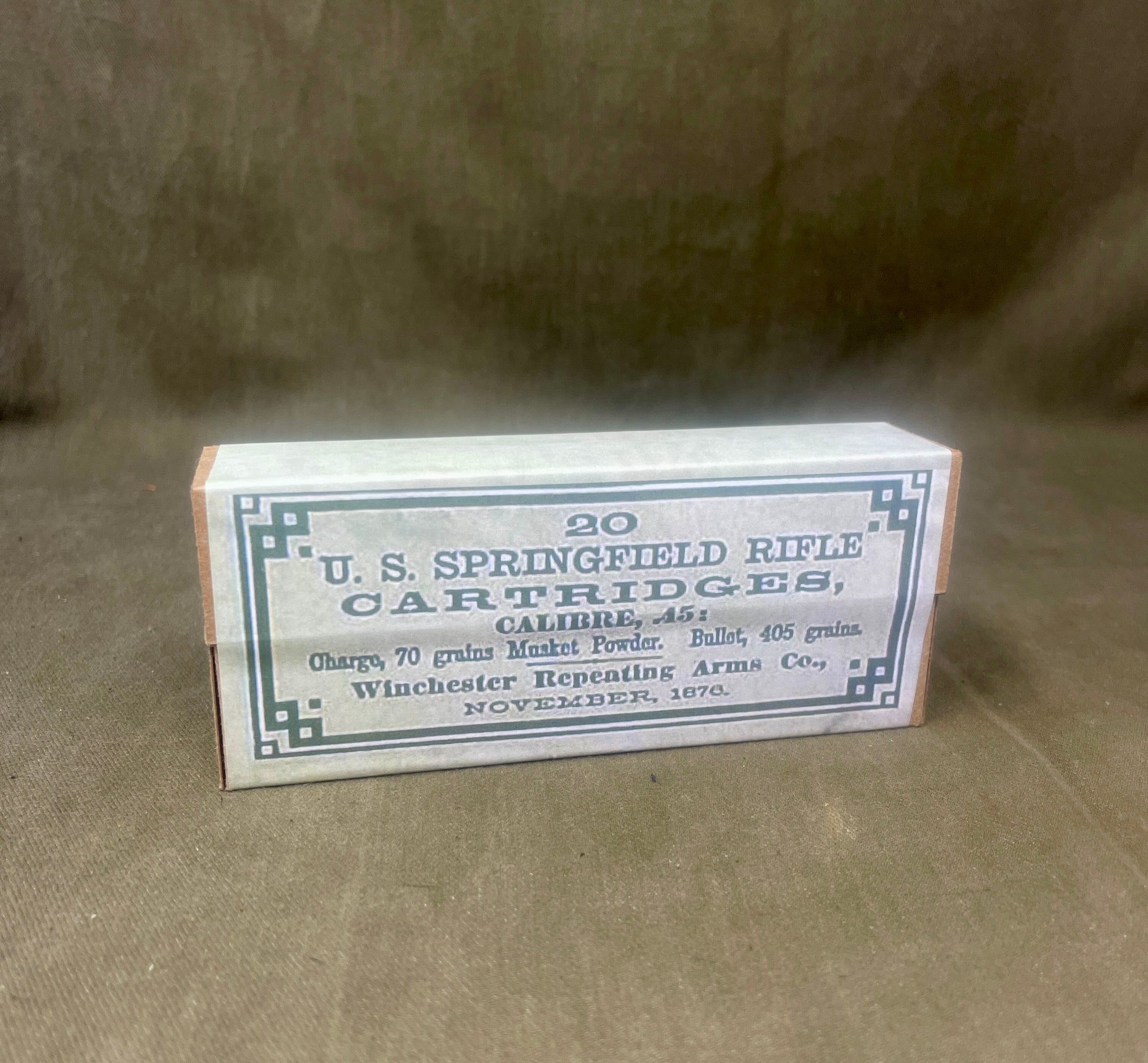 Box of U.S. Springfield rifle cartridges on a brown background