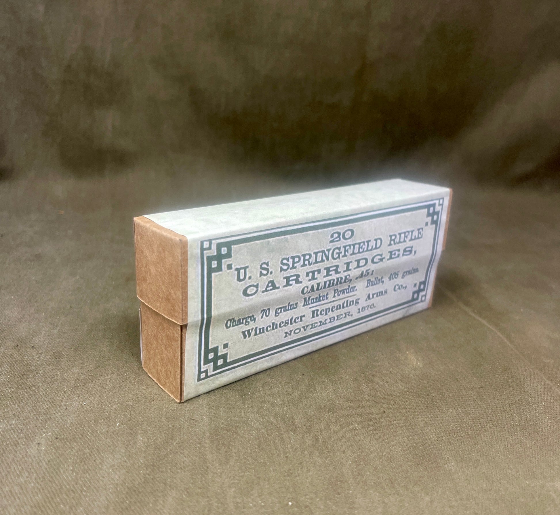 Box of U.S. Springfield Rifle Cartridges on a brown background
